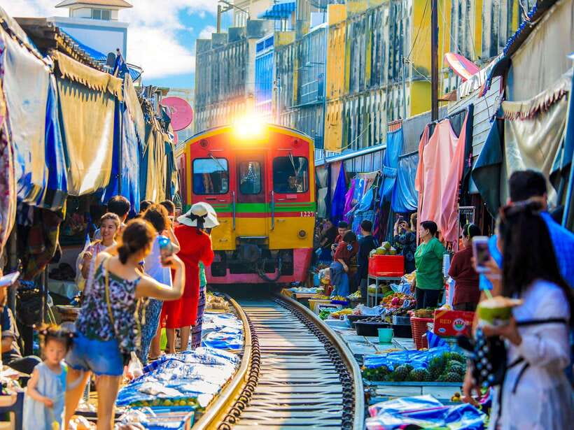 Bangkok: Maeklong Railway & Amphawa Floating Market Day Trip - Maeklong Railway Market and the train that cuts through it