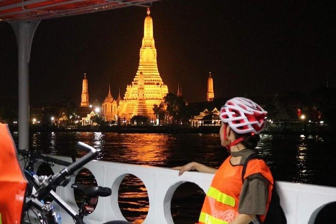 Bike Bangkok at Night with Thai Dinner - Wat Arun glowing across the river