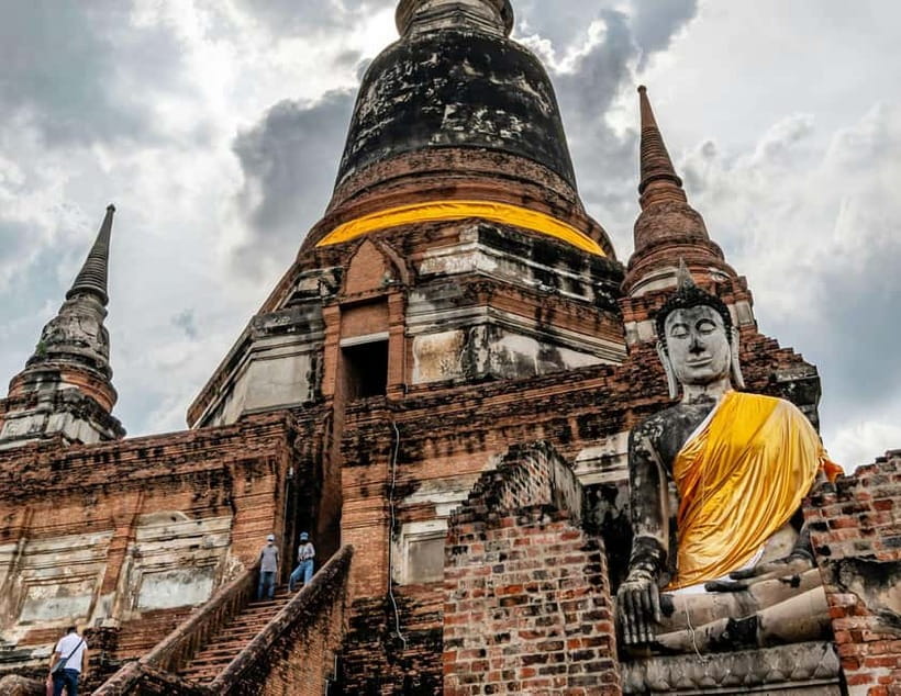 From Bangkok: Ayutthaya Heritage Tour with Sunset Boat Ride - Wat Maha That and the famous Buddha in the roots