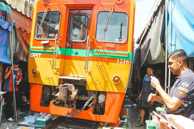 Maeklong Railway Market and Damnoen Saduak Floating Market Tour From Bangkok - Maeklong Railway Market and the train that cuts through it